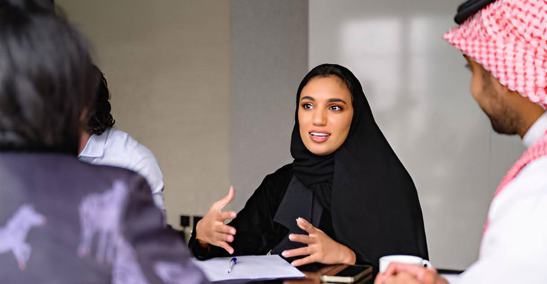 woman in modest wear discussing about expanding business