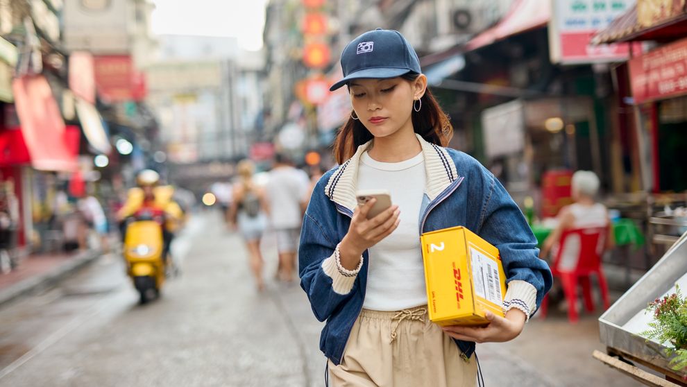 young female fashion entrepreneur collecting her DHL parcel