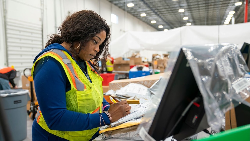 dhl staff checking hs codes at a logistics centre
