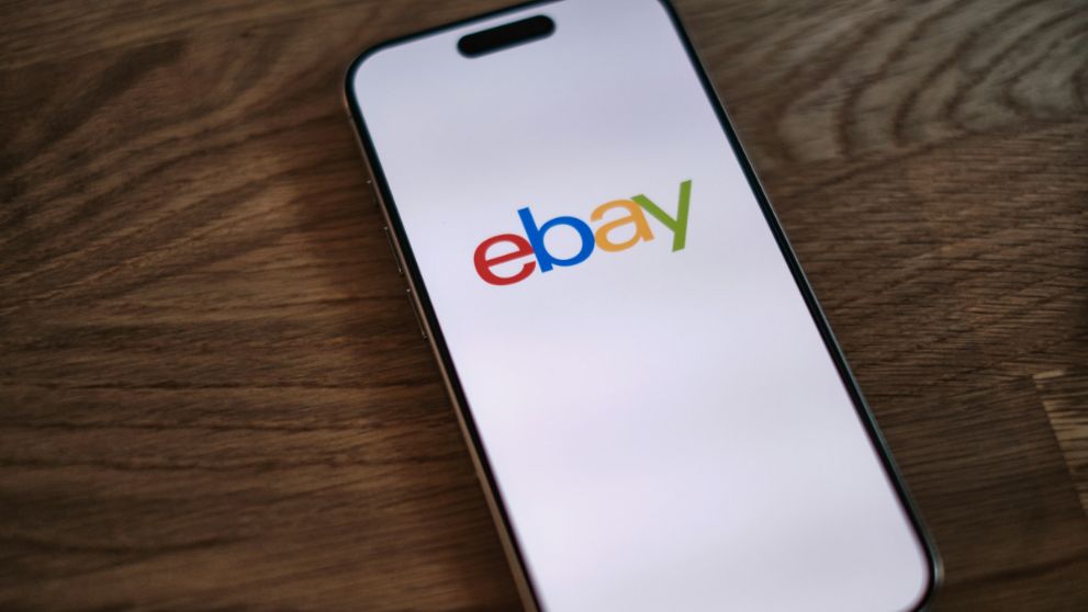 mobile phone on table displaying ebay logo