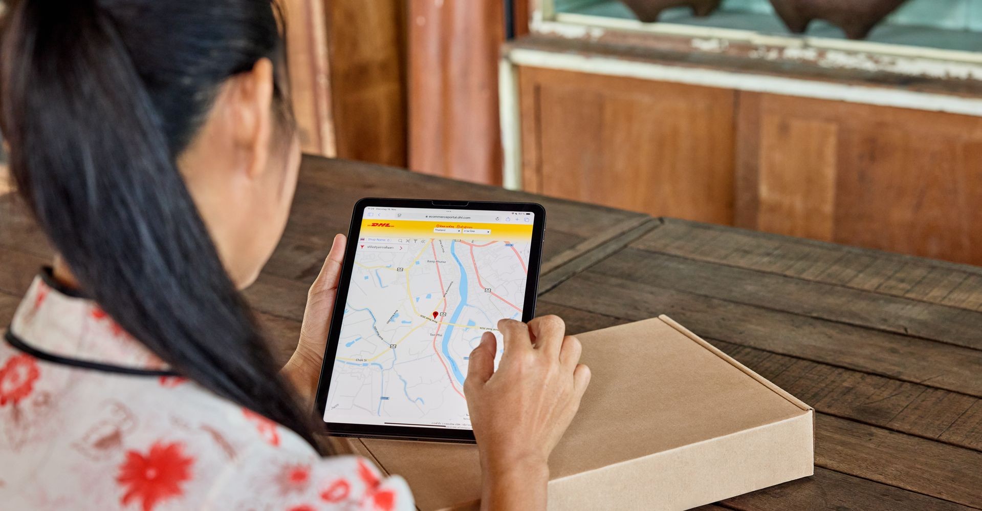 a woman using a tablet to check for electronic proof of delivery