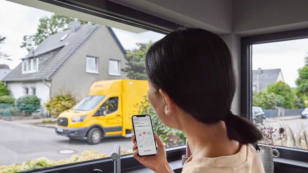 customer using phone for dhl parcel tracking
