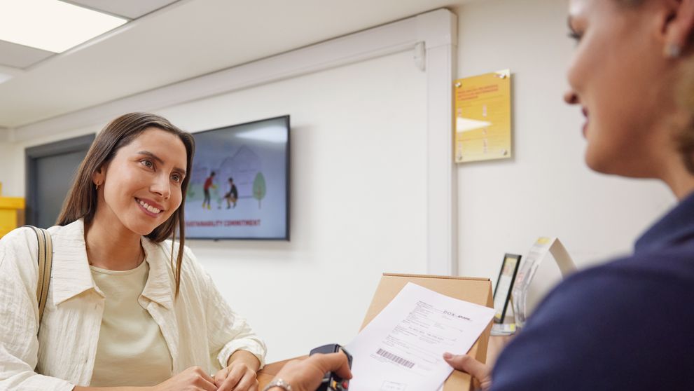 woman sending an overseas shipment with an air waybill at dhl express
