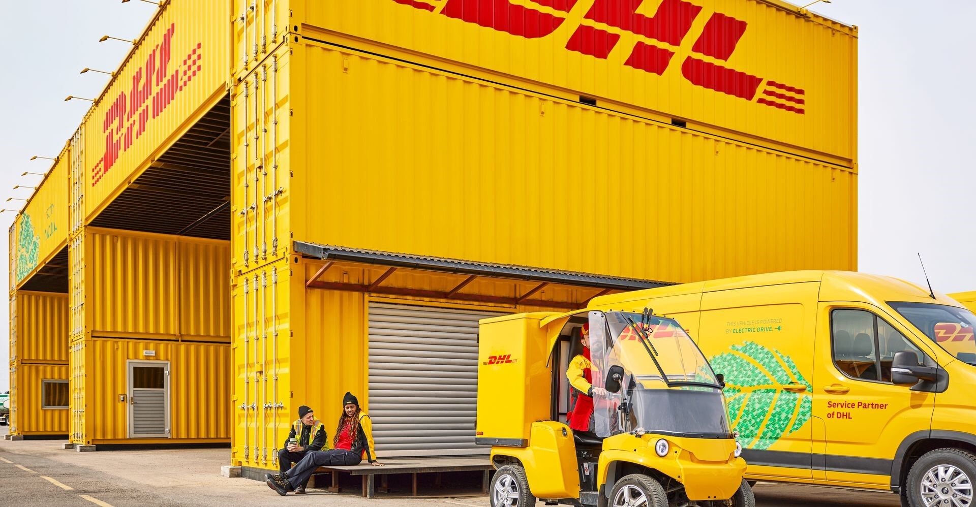 dhl employees going about their work routine outside the freight hub