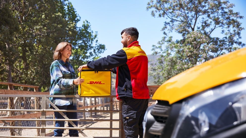  A male DHL employee collecting coffee bean exports with a specific reusable DHL 