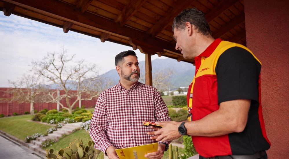 a dhl employee delivers an express envelope to a customer