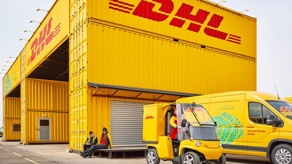 dhl employees going about their work routine outside the freight hub