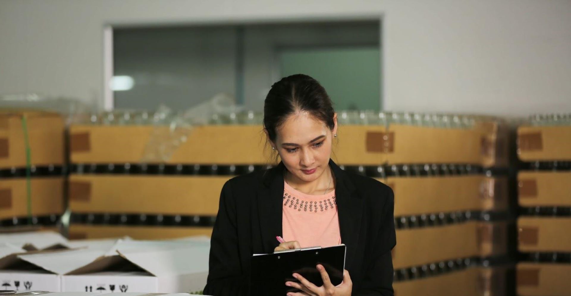 woman checking material safety data sheet before shipping goods
