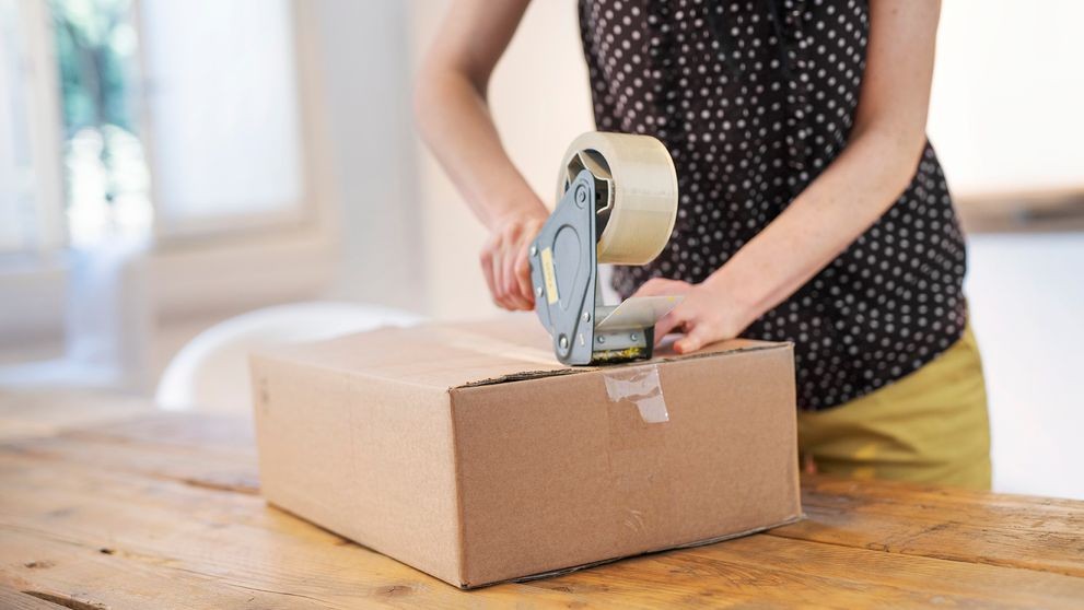 a woman taking measures to protect her package from shipment damage