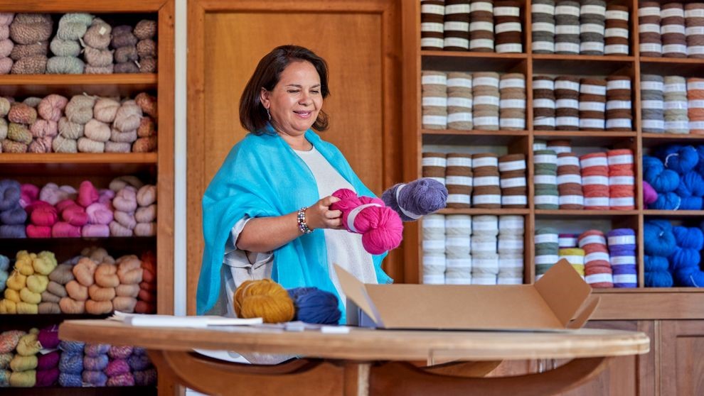 woman packing products for small business shipping