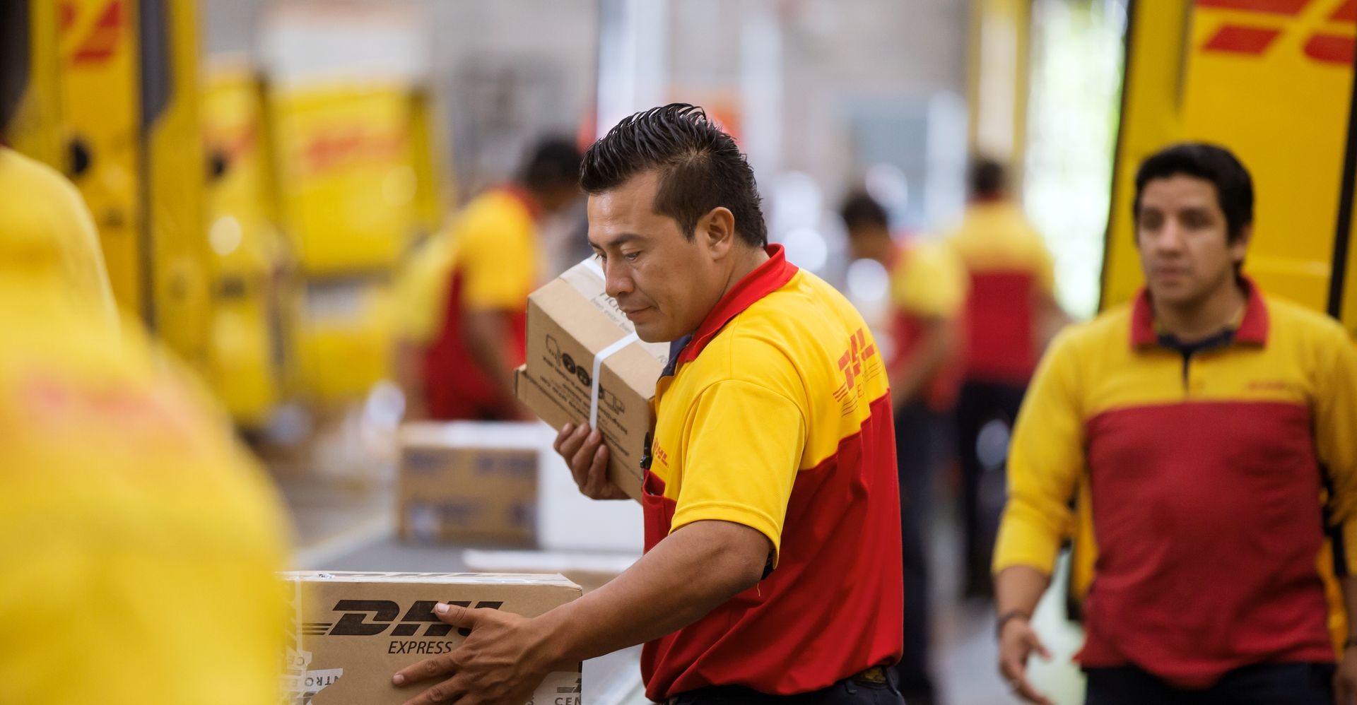 Parcels being loaded and processed at a DHL Express warehouse