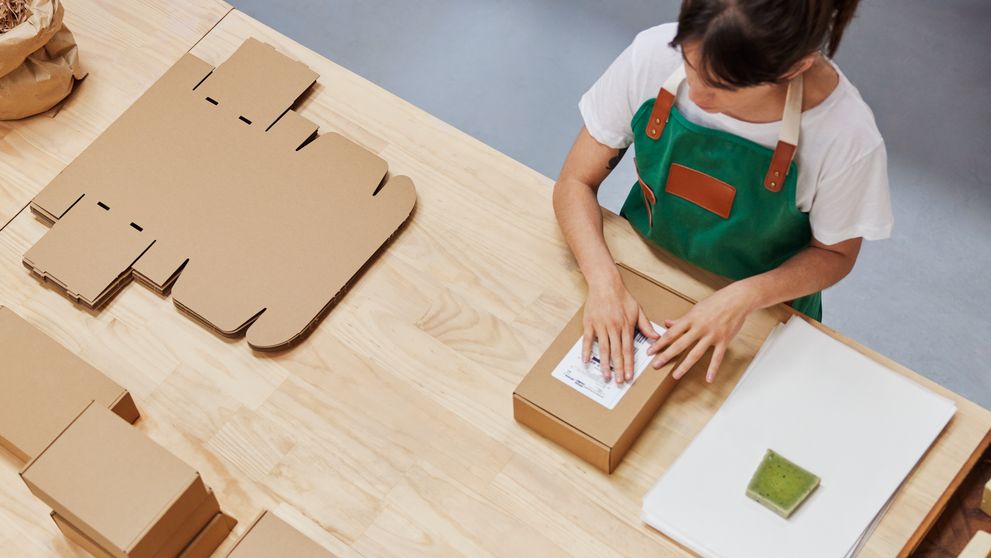 store owner packaging goods for express delivery to customers