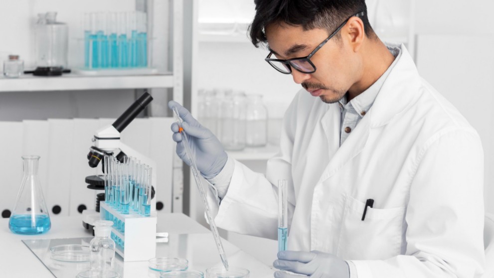 A doctor working in specialty pharma running tests in a lab