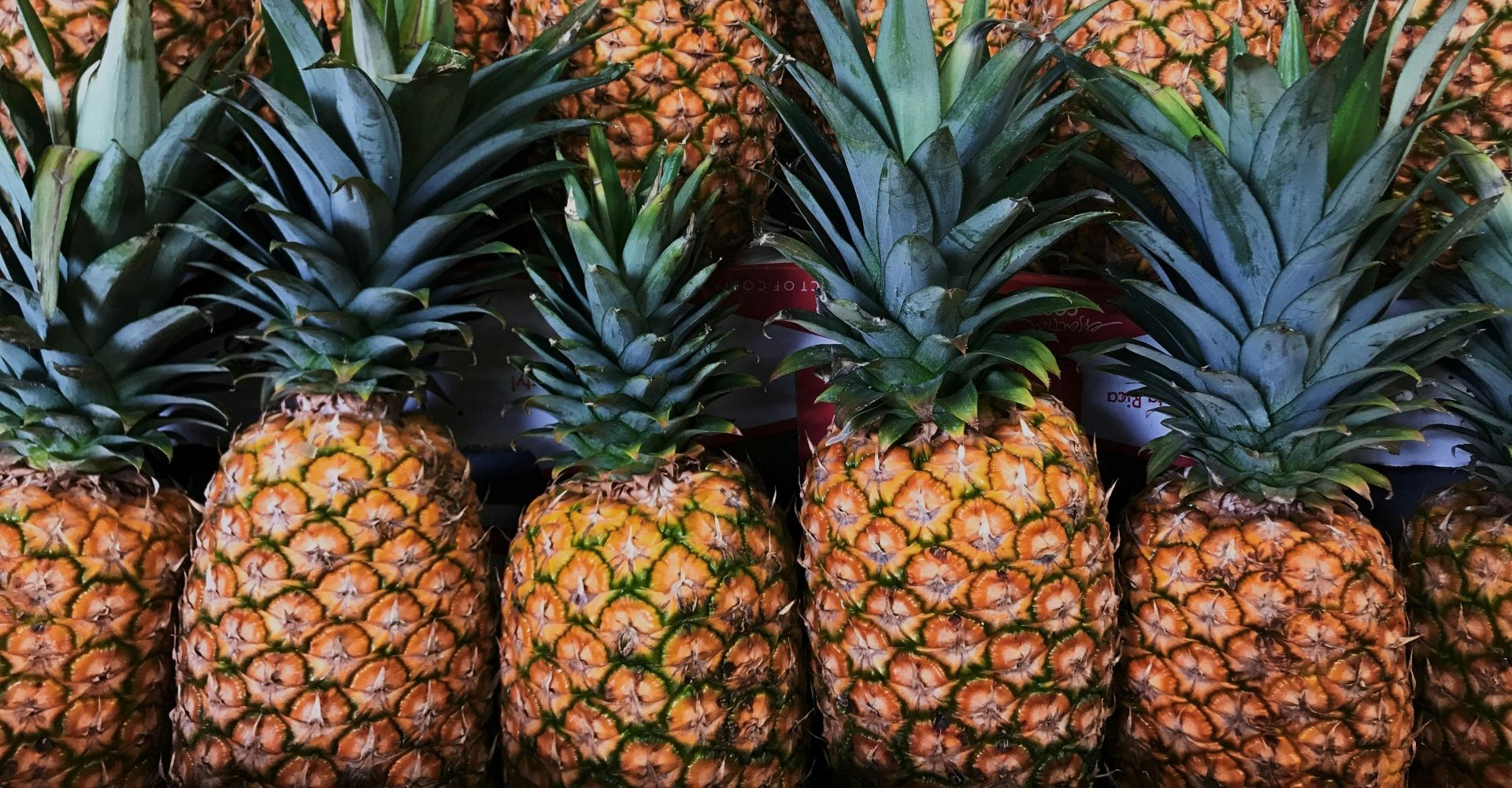 Fresh pineapples stacked closely together, showcasing the quality of pineapple exports from Sri Lanka.