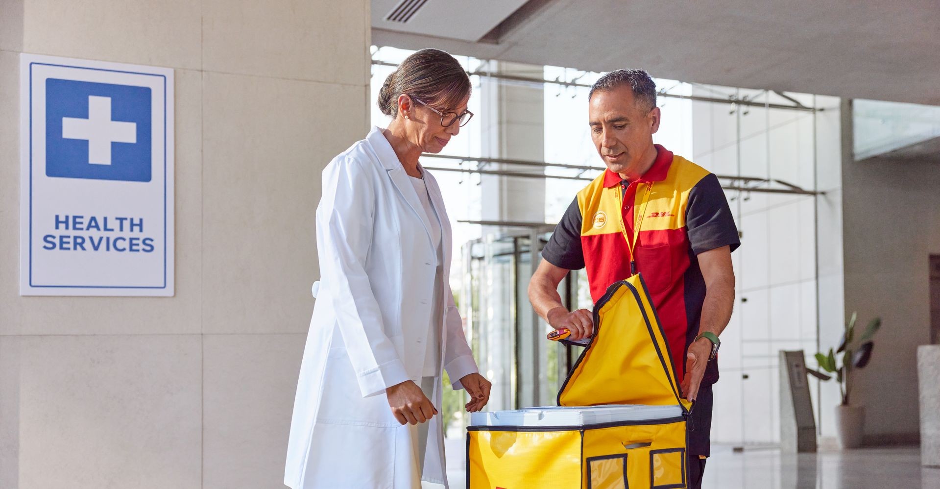 DHL Express employee applies a label to the parcel, ensuring the safe and compliant sending of medicine abroad.