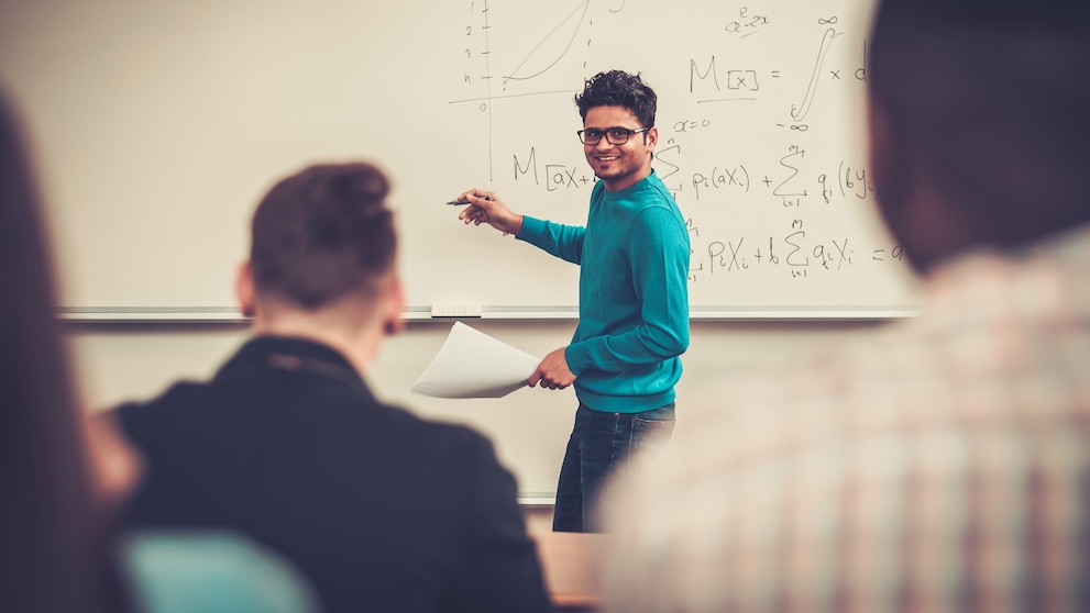 Multinational group of cheerful students taking an active part in a lesson while sitting in a lecture hall.; Shutterstock ID 393668236; purchase_order: 0018234; job: D0312973; client: DHL Express; other: DHL LK: Industry Specific Campaign 2022
