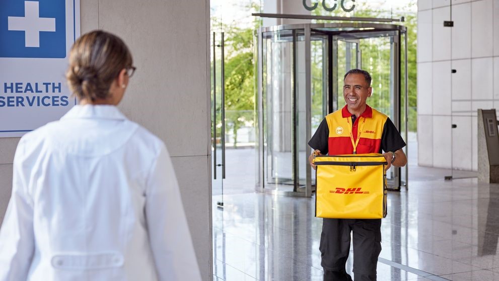 dhl express employee delivering temperature sensitive products to a hospital