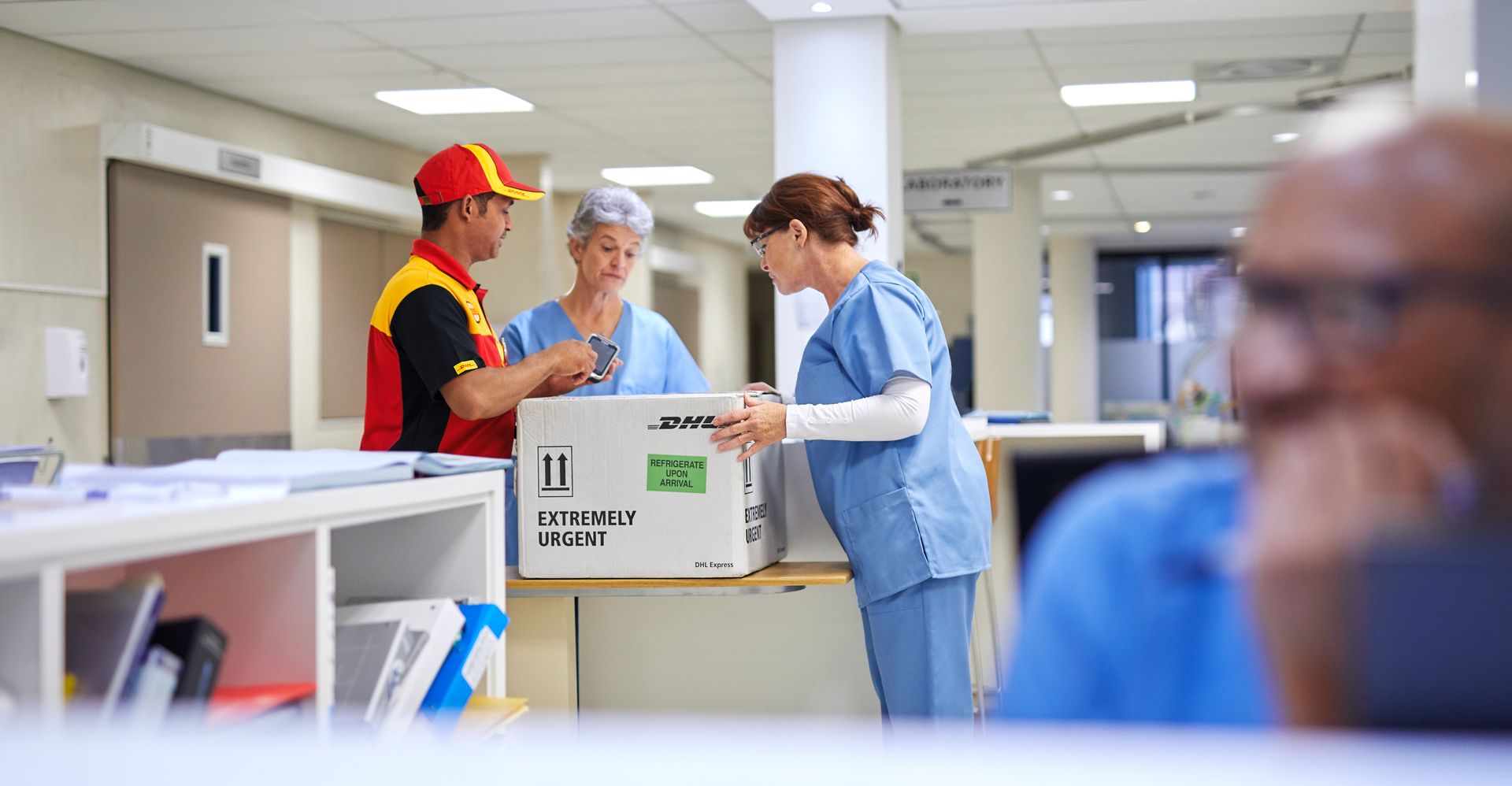 healthcare professionals receiving medical supplies from dhl courier
