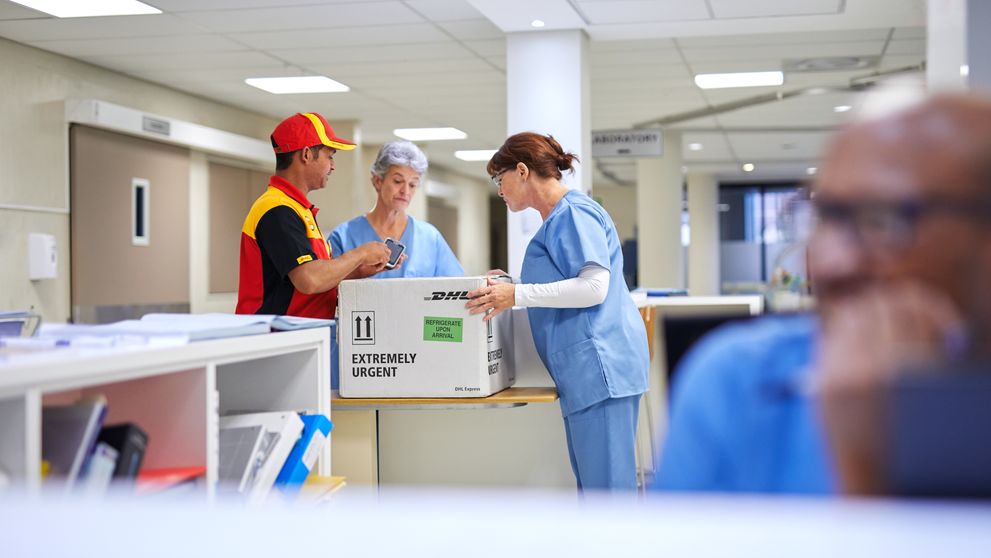 healthcare professionals receiving medical supplies from dhl courier