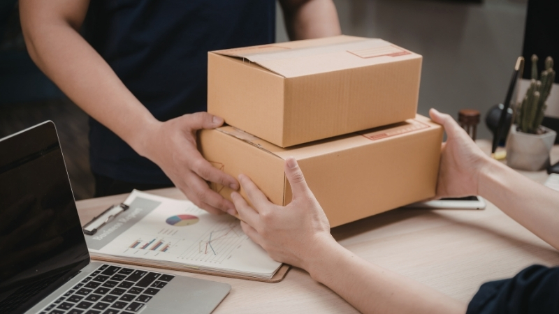 hands that give boxes to others