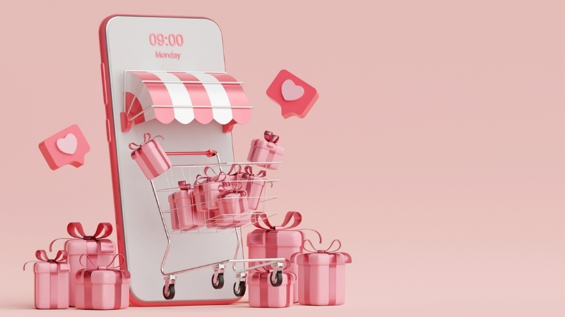 Pembe hediye kutuları ve beğenileriyle mobil alışveriş sepeti