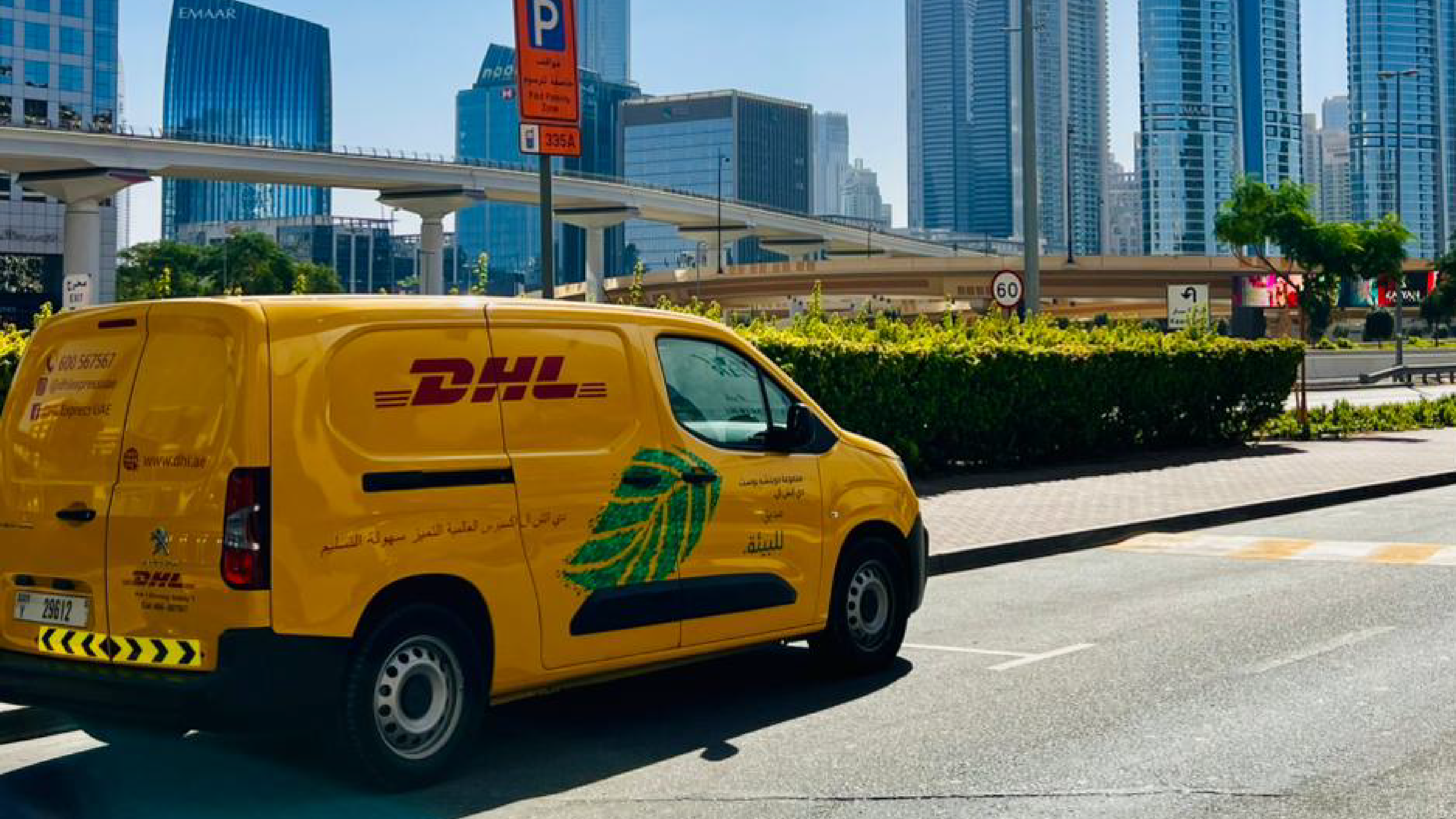 yellow DHL van besides a bridge