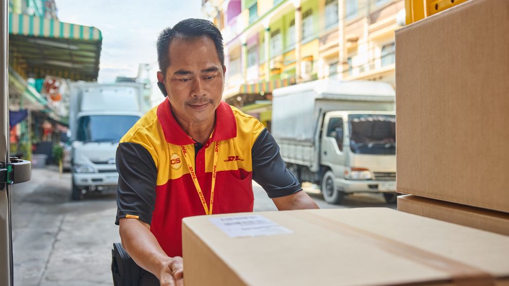 dhl express employee handling parcel 