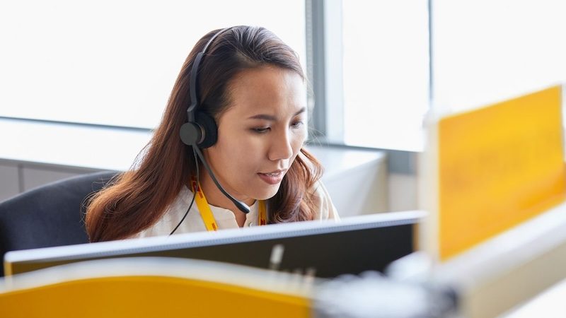 dhl express employee upholding international business etiquette while on a call