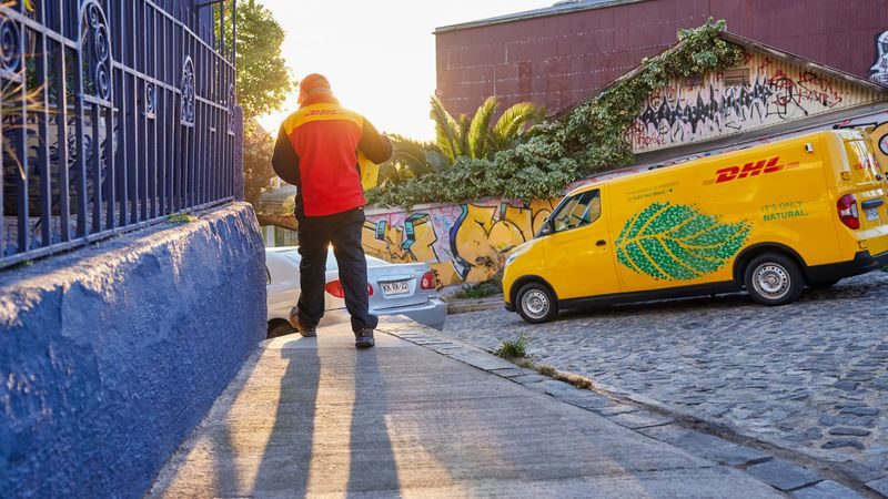 dhl staff delivering international package shipped using dhl express neutral delivery service