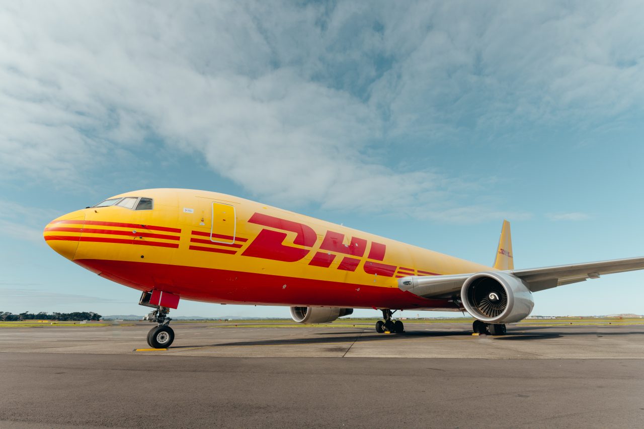 a DHL plane sits on a runway
