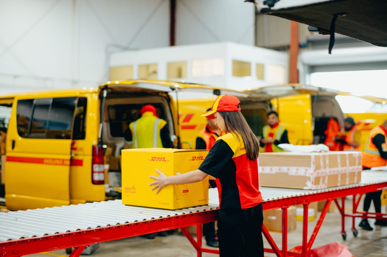 courier moving a parcel along a roller