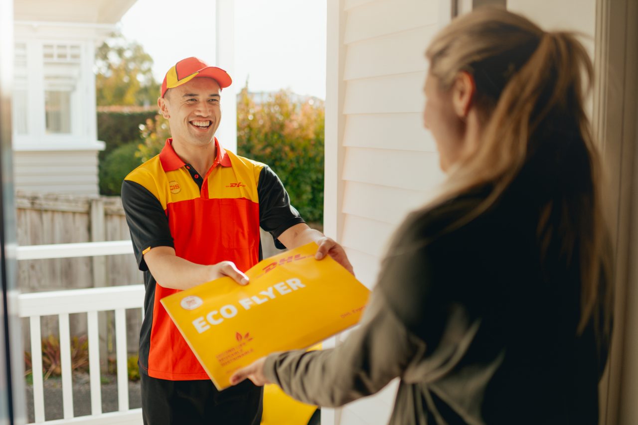 courier handing a parcel to a customer