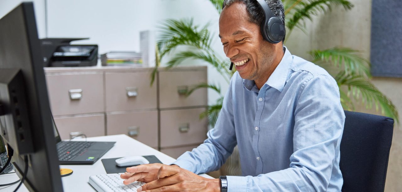 Man talking through a headset while at work