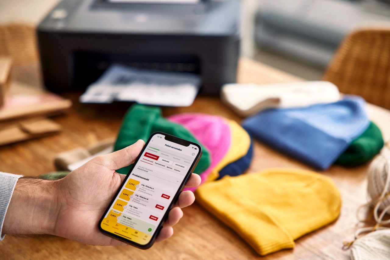 Smartphone with DHL label buying process.